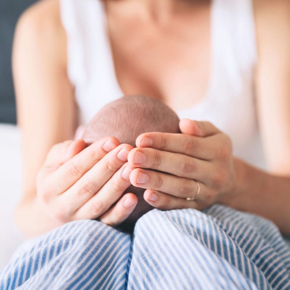 Mother cradling her newborn baby, representing lifelong care planning for children affected by birth injuries and obstetric malpractice