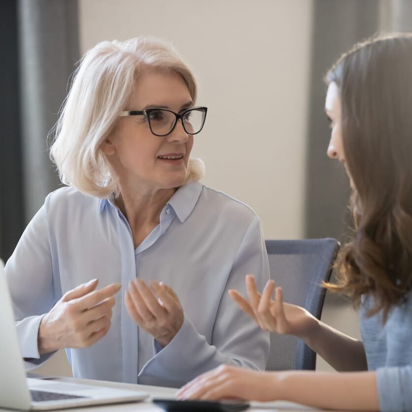 life care planner discussing a future care report with a client across a laptop